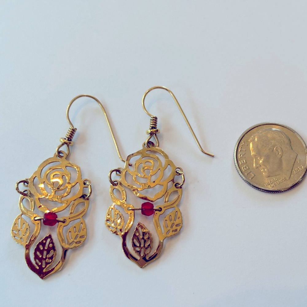 Wild Bryde gold earrings roses with a red stone.